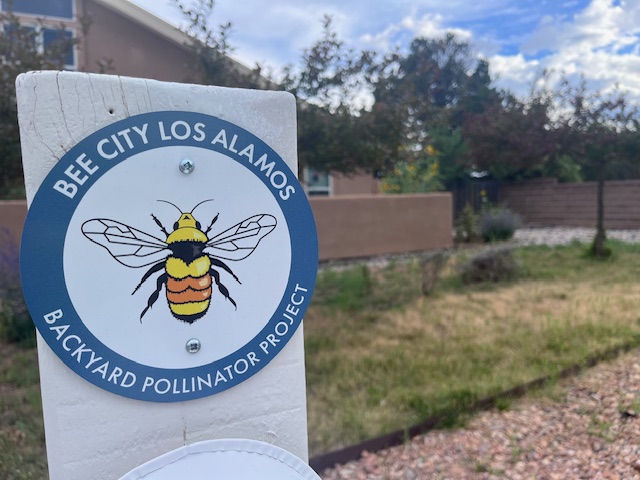 Bee City Los Alamos Backyard Pollinator Project sign in a yard